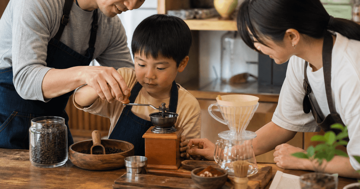 親子で手回しミルを使ってコーヒー豆を挽く様子